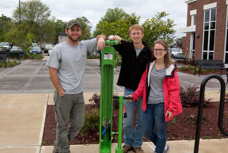 three students at bike repair station