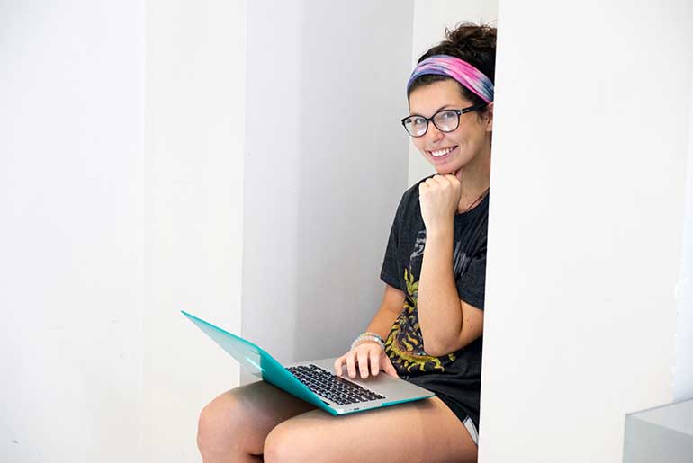 young lady studying with laptop computer