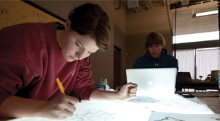 women designing schematics on a desk