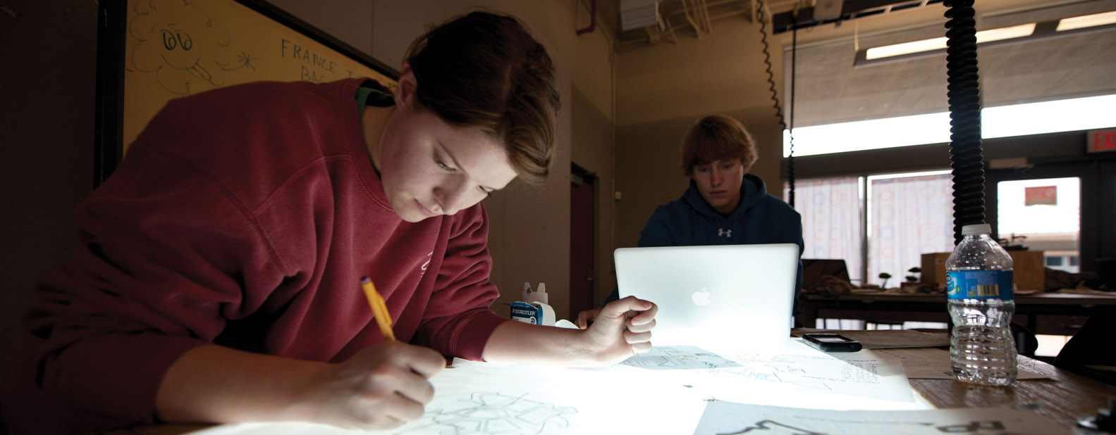 women designing schematics on a desk