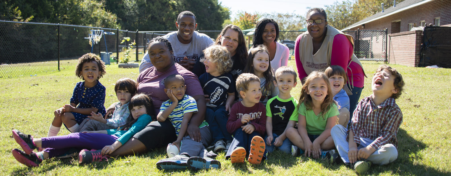 Teachers with students in a playground