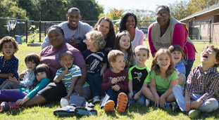 Teachers with students in a playground