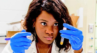 Student in a lab with a test tube in her hand