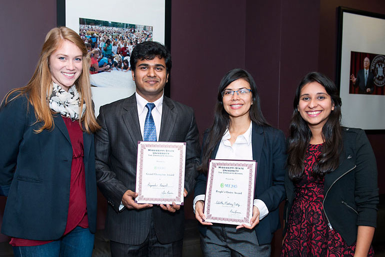 students pose with plaques