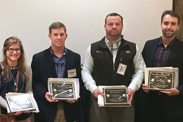 four students with plaques