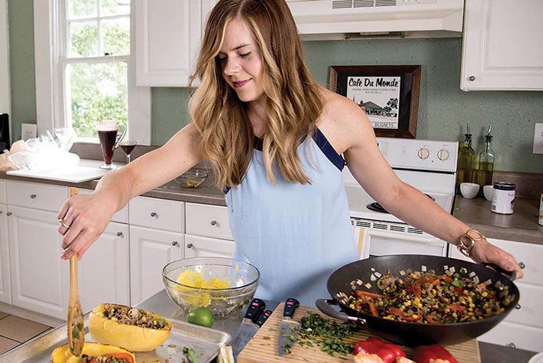 female preparing menu item in kitchen