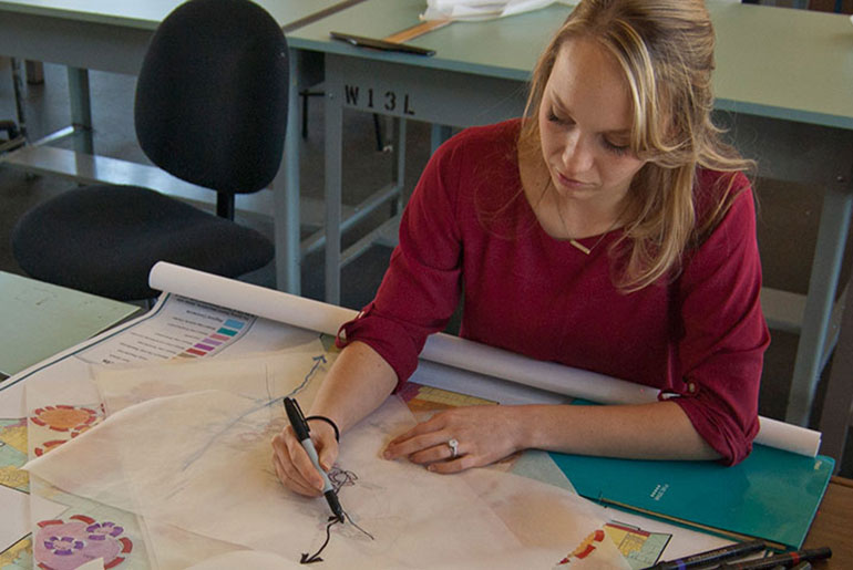female student drafting a landscape design