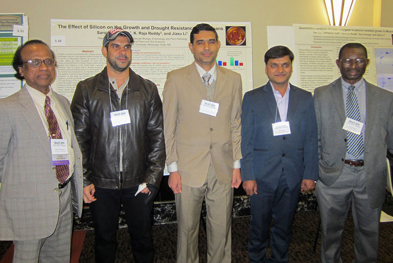 five males posting at a conference