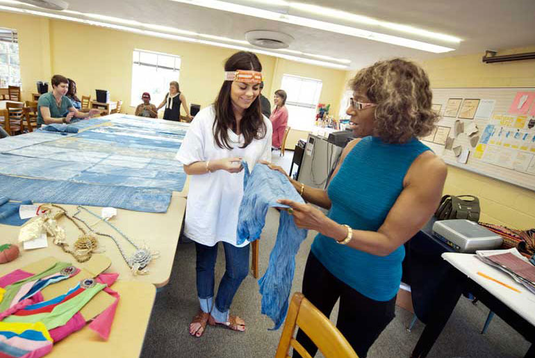 faculty and student look at fabric samples