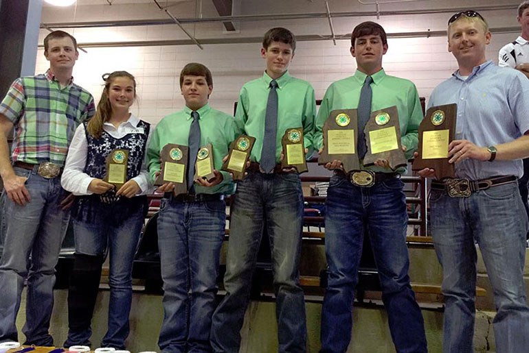 4-H students pose with plaques