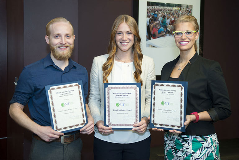 three students pose with certificates