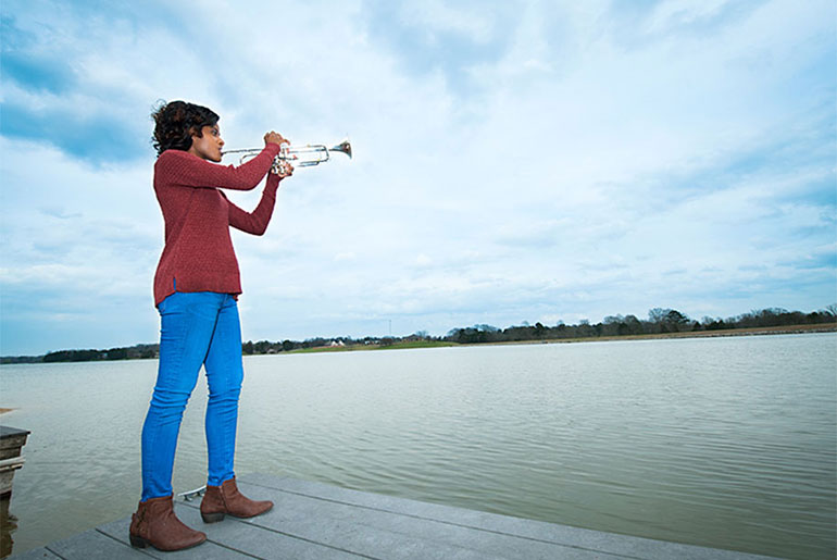 female student playing trumpet