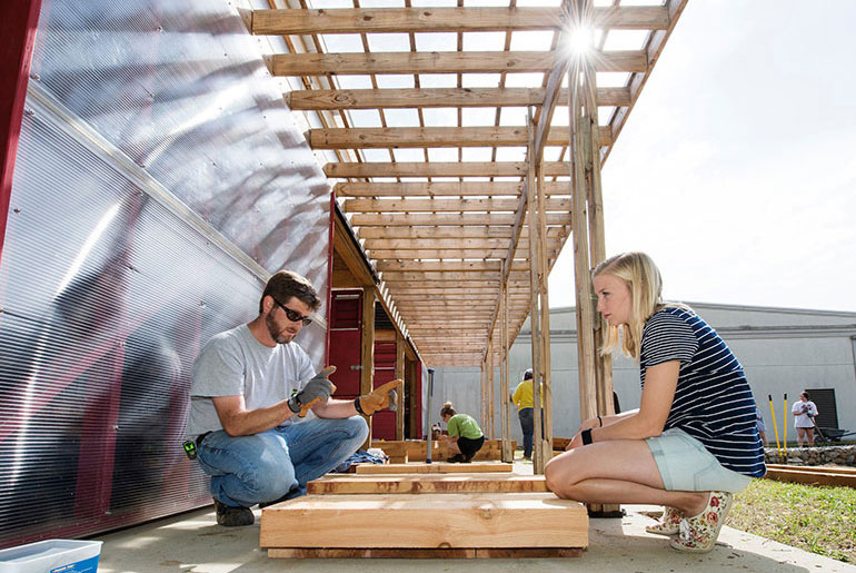 male professor and female student at community garden