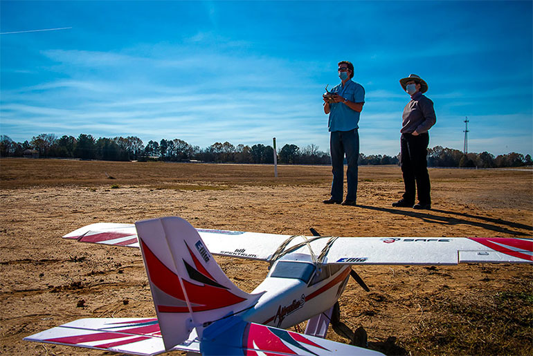 Kevin Wise flies a drone while Amelia Fox looks on. 