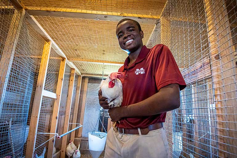 Rodney Self holding a laying hen