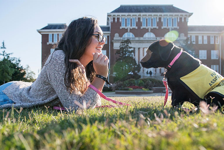 Maya Harlow with a puppy in training