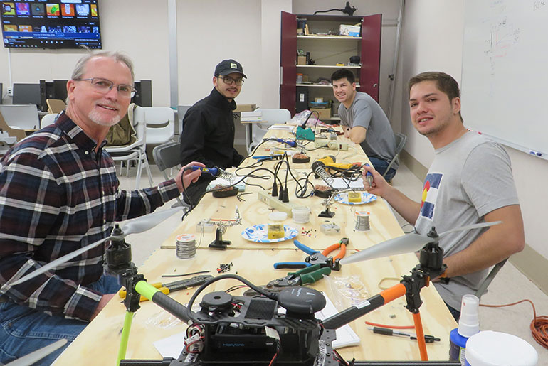 Louis Wasson, Nitant Rai, Hunter Blalock, and Antonio Correa Tavares build drones in an ag flight technologies course this semester.
