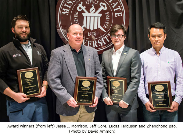 Research award winners with plaques