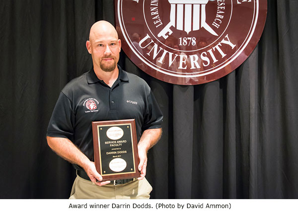 Service Award winner with plaque