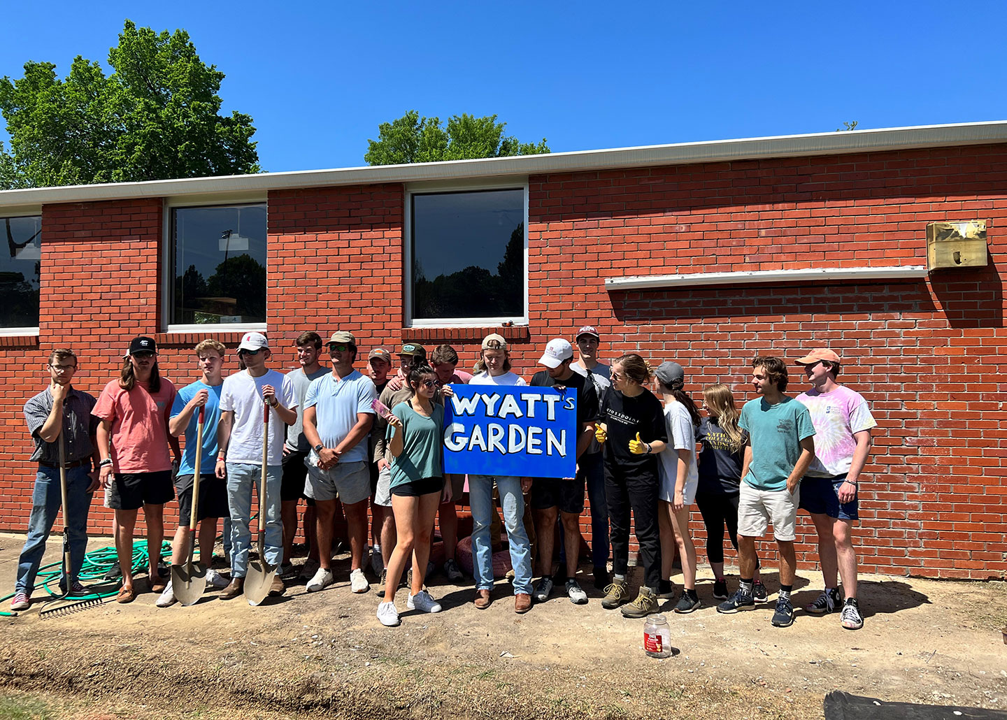 Students holding a sign for the Wyatt Garden
