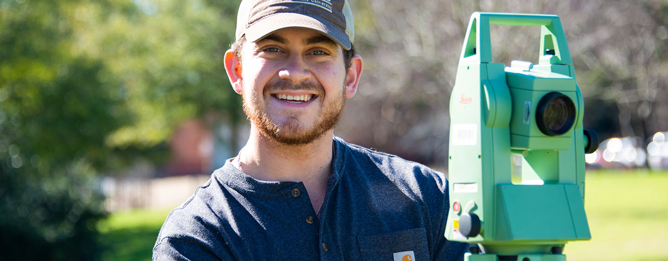 Student with surveying equipment