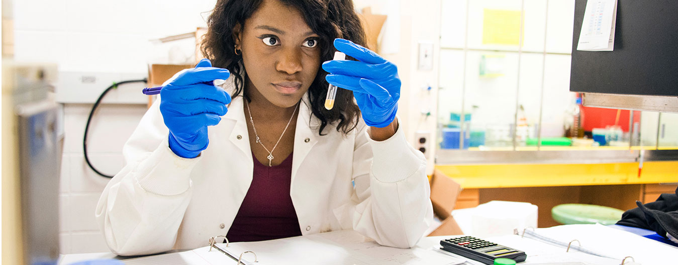 Female student looking at test tube