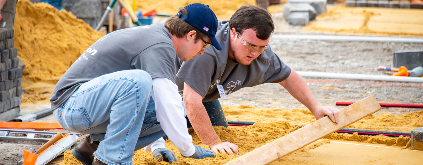 Male students framing sidewalk