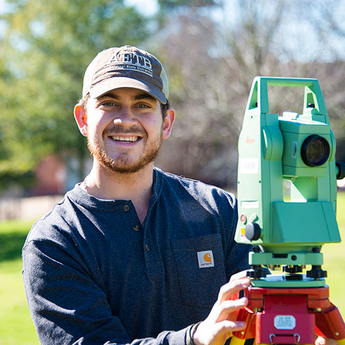 Student with survey equipment