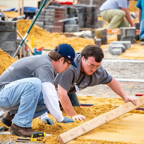 Landscape contracting students working with wood